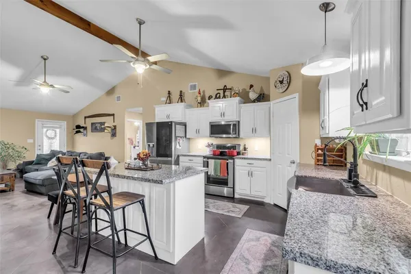 a kitchen with stove and cabinets