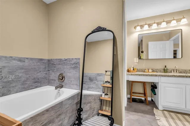 a bathroom with a bathtub and a sink