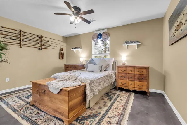 a bedroom with a bed and a ceiling fan