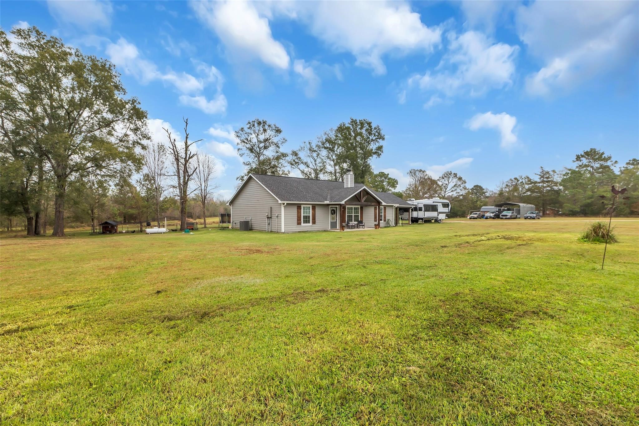 696 Independence Road Shepherd, TX 77371 - Photo 24 of 27 a view of a house with yard and lake view