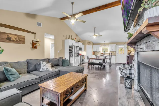 a living room with furniture and a chandelier