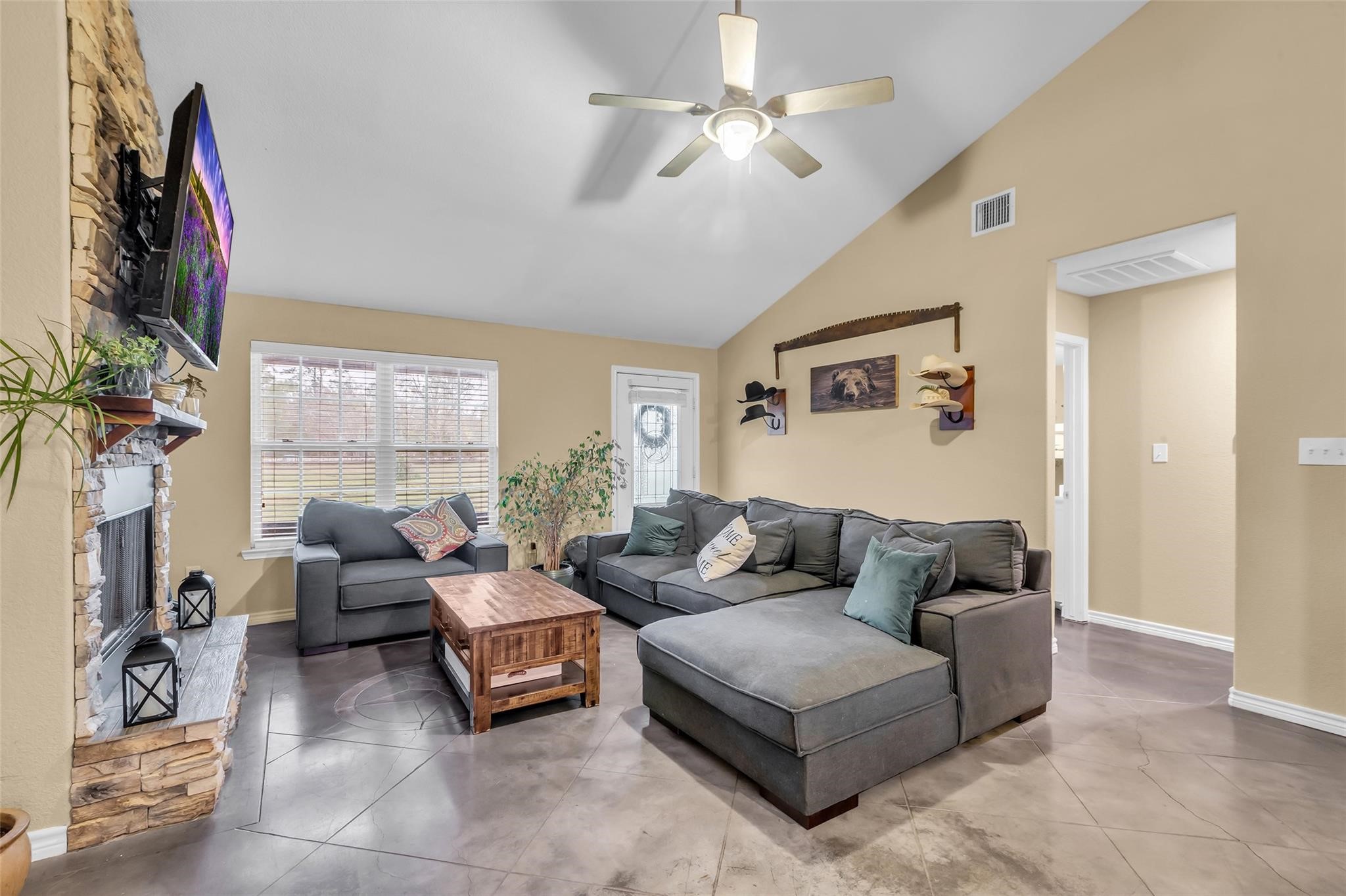 696 Independence Road Shepherd, TX 77371 - Photo 5 of 27 a living room with furniture a large window and a flat screen tv