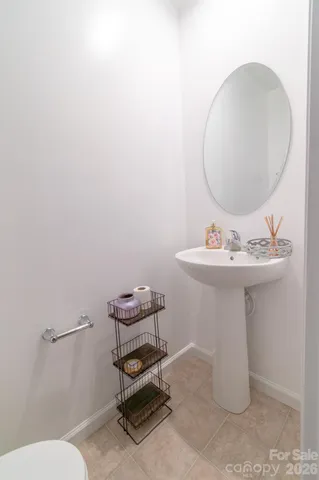 a bathroom with a sink mirror and toilet