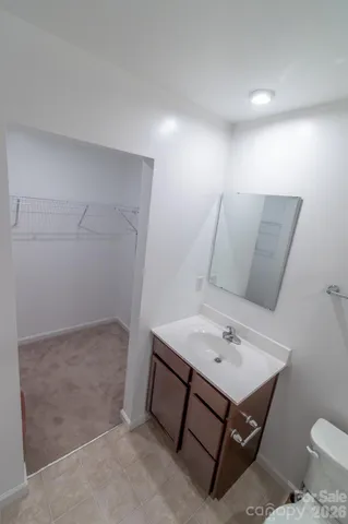 a bathroom with a sink toilet and mirror