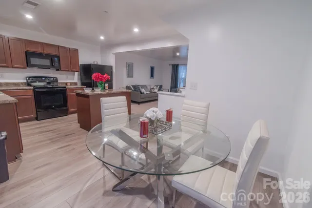 a living room with furniture and kitchen view