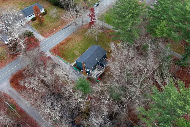 an aerial view of a house with a yard