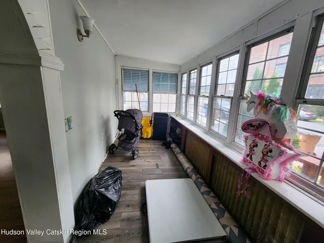 a view of a hallway with furniture and a window