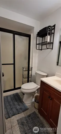 a bathroom with a toilet a sink and a mirror
