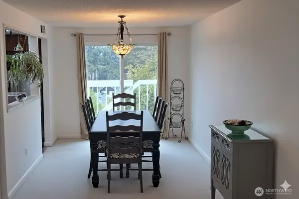 a dining room with furniture potted plants and wooden floor