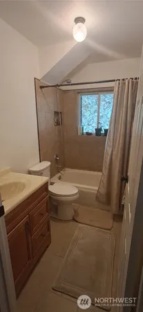 a bathroom with a granite countertop sink a mirror and a bathtub