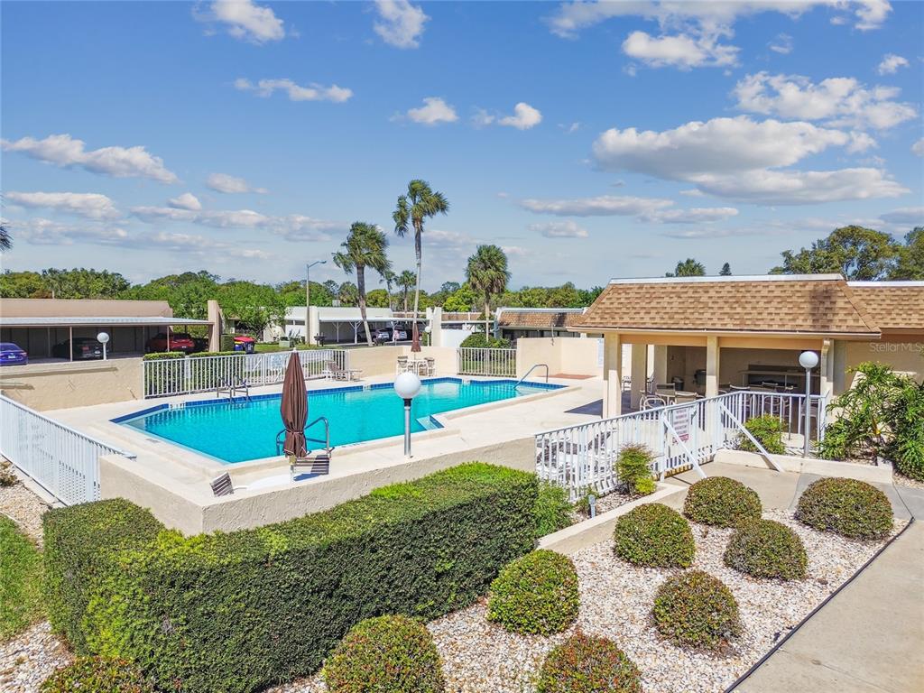 11340 Carriage Hill Drive, Unit 4 Port Richey, FL 34668 - Photo 25 of 36 a front view of a house with a yard