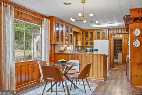 a view of a dining room with furniture window and wooden floor