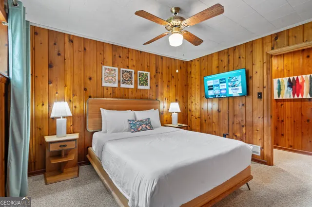 a bedroom with a bed and a painting on the wall