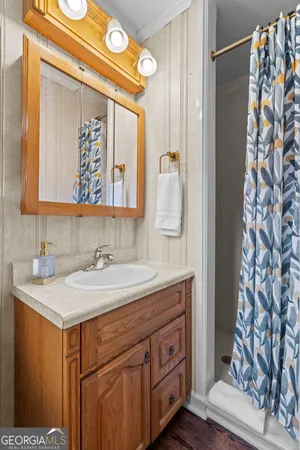 a bedroom with a bed lamp and a window