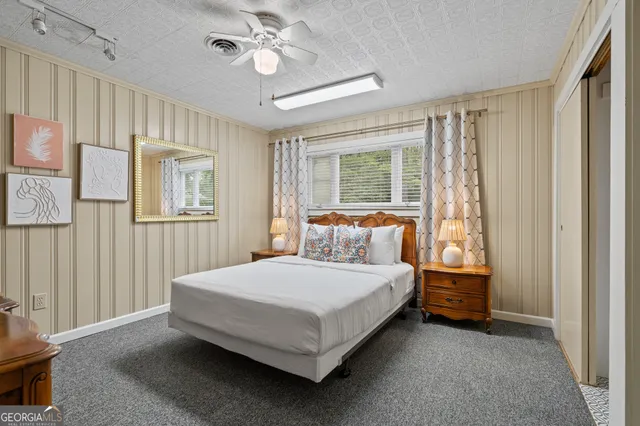 a bedroom with a bed and a flat screen tv in it