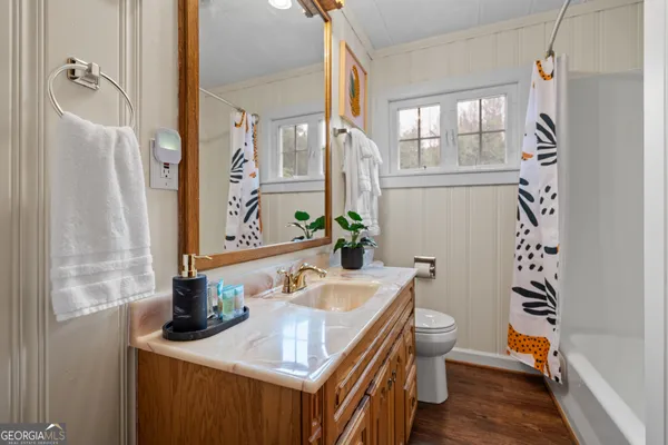 a view of a house with a big yard and large trees