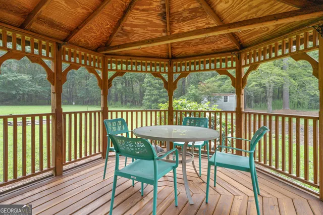 a view of a house with a backyard and balcony