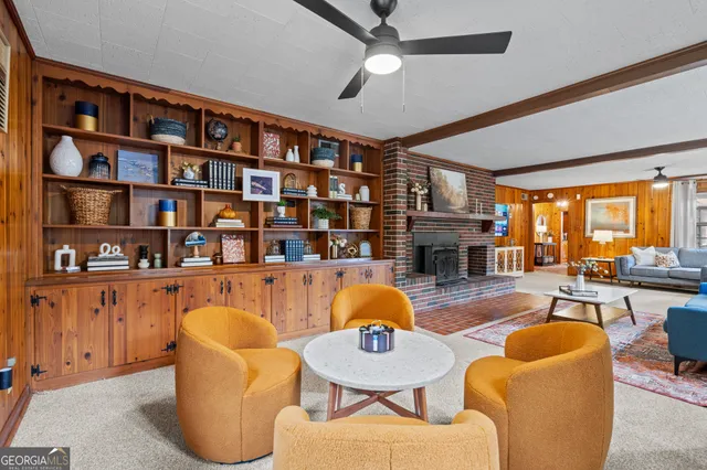 a living room with furniture fireplace and a table