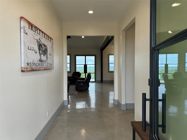 a view of a hallway with livingroom and furniture
