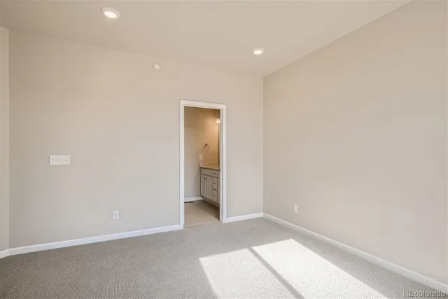 an empty room with closet and sliding door