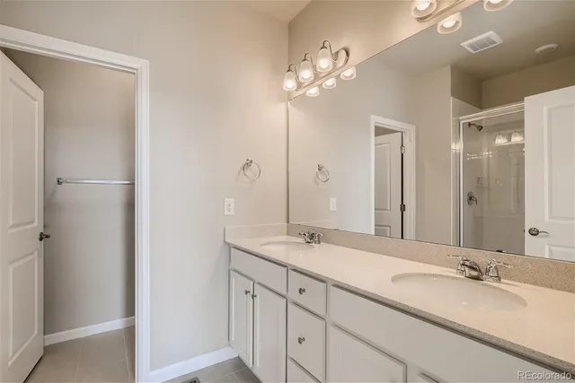 a bathroom with a double vanity sink and a mirror