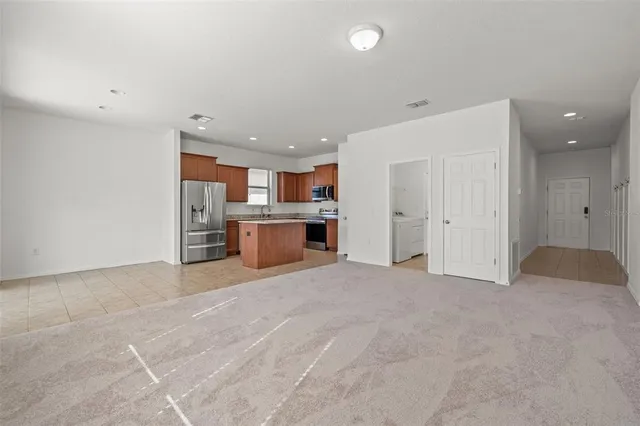 a view of a kitchen with a sink and white cabinets
