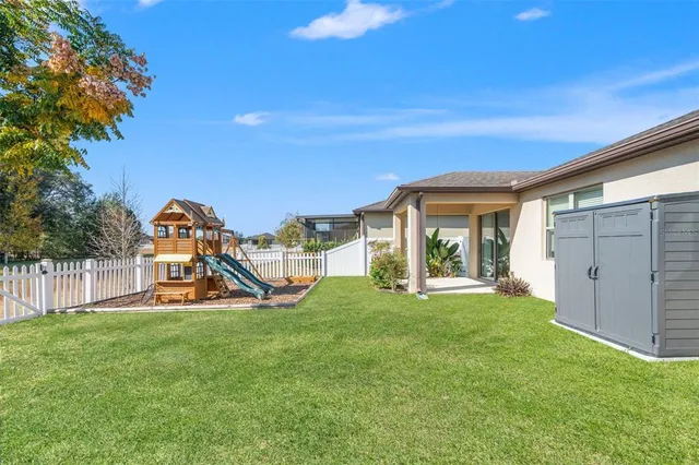 a view of a house with backyard and porch