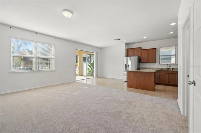 a view of kitchen with a sink and cabinets