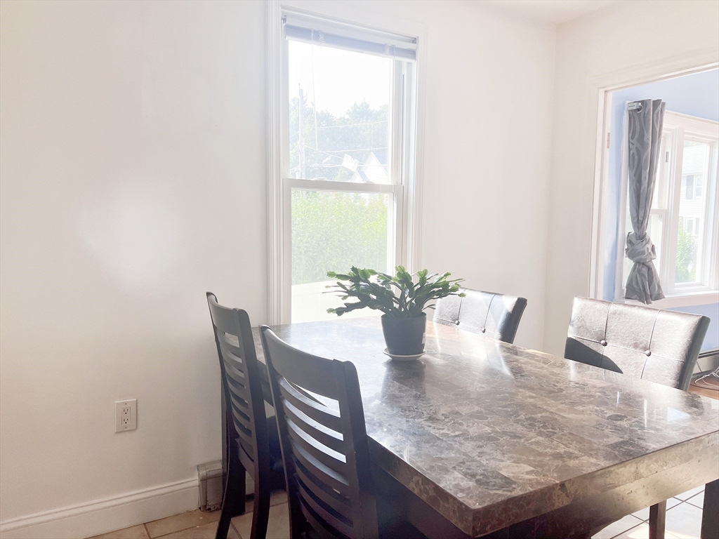 68 Maple Street Melrose, MA 02176 - Photo 11 of 39 a view of a dining room with furniture and a window