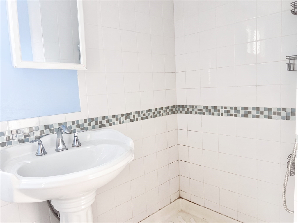 68 Maple Street Melrose, MA 02176 - Photo 12 of 39 a bathroom with a sink and a mirror