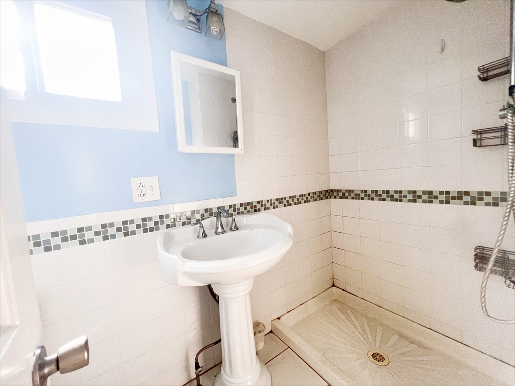 68 Maple Street Melrose, MA 02176 - Photo 13 of 39 a bathroom with a sink and a mirror
