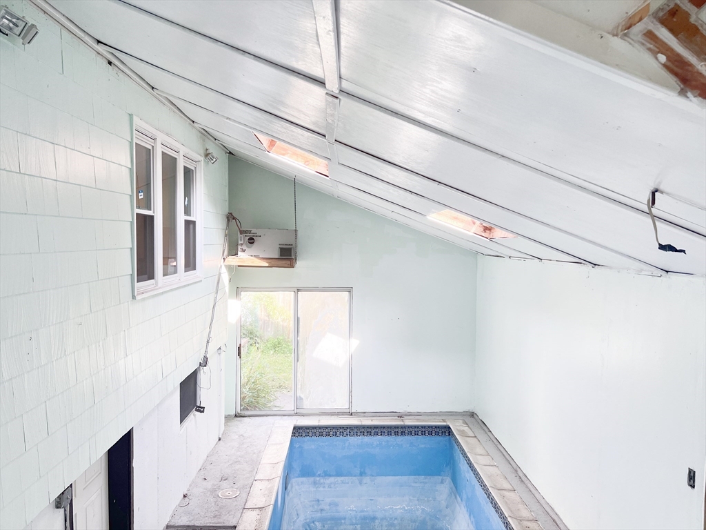 68 Maple Street Melrose, MA 02176 - Photo 19 of 39 a view of a hallway with wooden floor and staircase