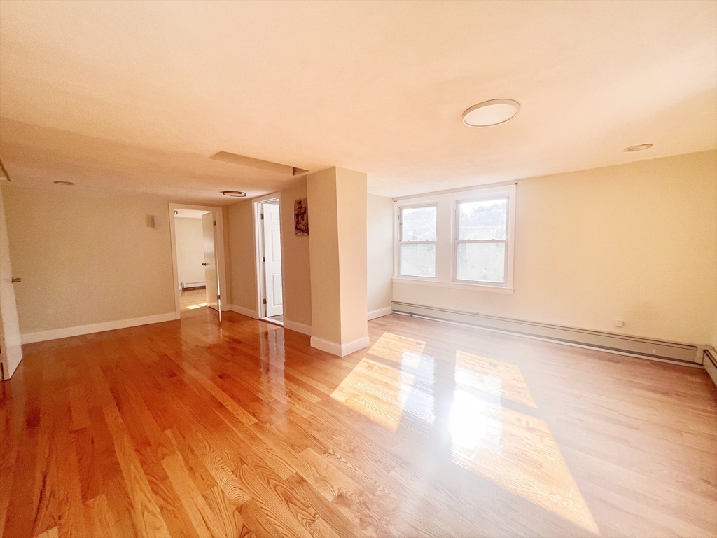 68 Maple Street Melrose, MA 02176 - Photo 23 of 39 a view of empty room with wooden floor and fan