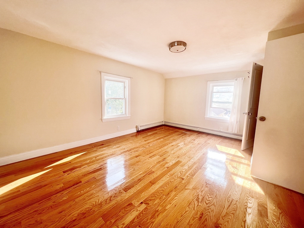 68 Maple Street Melrose, MA 02176 - Photo 27 of 39 an empty room with wooden floor and windows