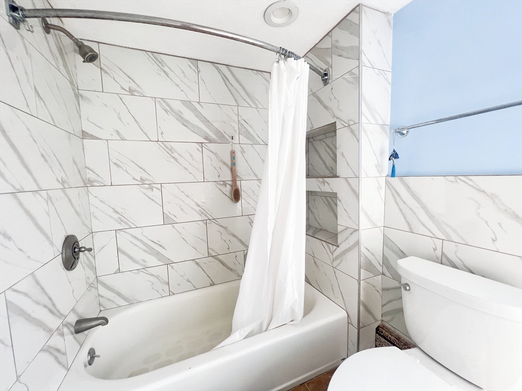 68 Maple Street Melrose, MA 02176 - Photo 28 of 39 a bathroom with a toilet and a bathtub