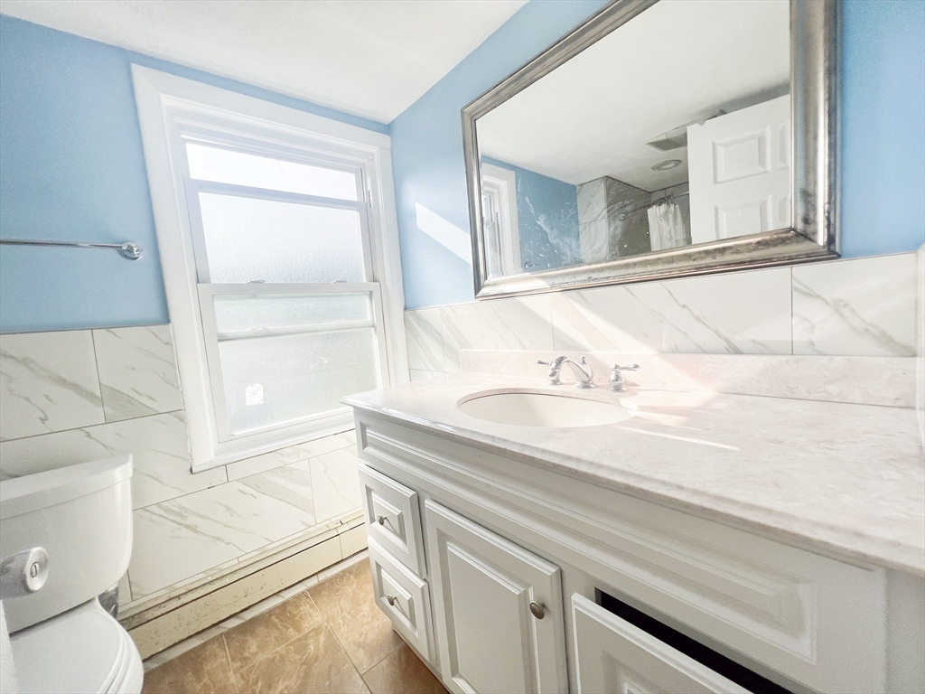 68 Maple Street Melrose, MA 02176 - Photo 29 of 39 a bathroom with a sink a toilet and vanity