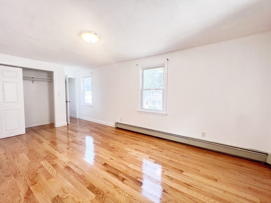68 Maple Street Melrose, MA 02176 - Photo 36 of 39 a view of an empty room with wooden floor and a window