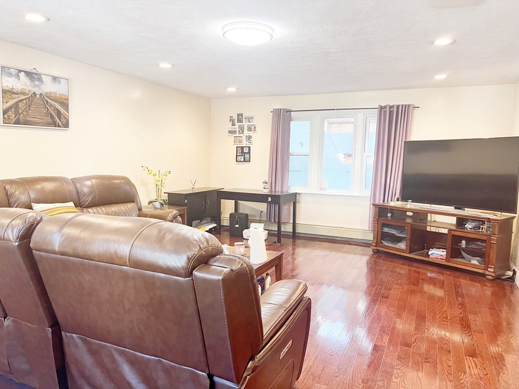 68 Maple Street Melrose, MA 02176 - Photo 4 of 39 a living room with furniture and a flat screen tv