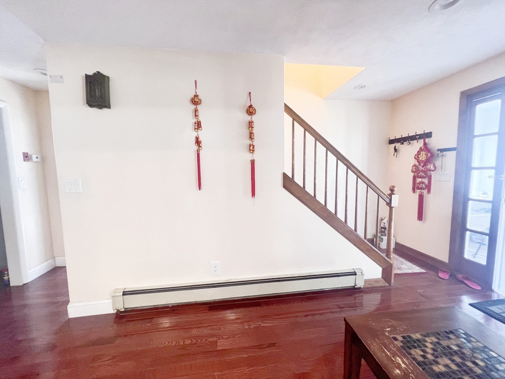 68 Maple Street Melrose, MA 02176 - Photo 5 of 39 a view of a livingroom with wooden floor and stairs