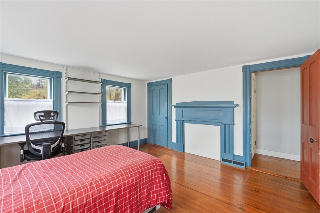 21 Rocky Hill Road Andover, MA 01810 - Photo 12 of 35 a bedroom with a bed and a fireplace