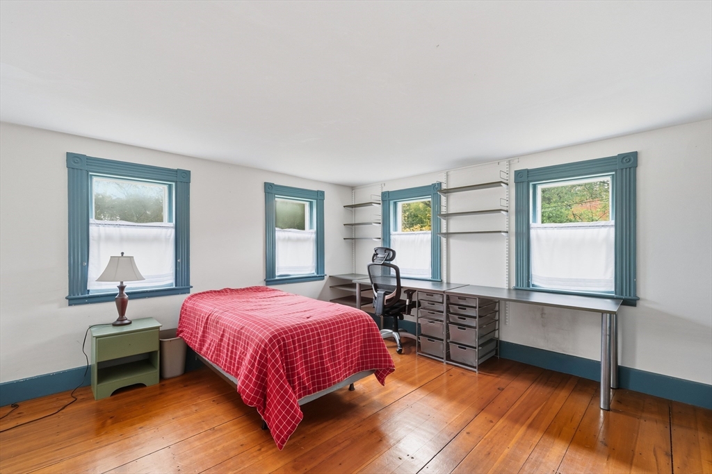 21 Rocky Hill Road Andover, MA 01810 - Photo 13 of 35 a bedroom with a bed and wooden floor