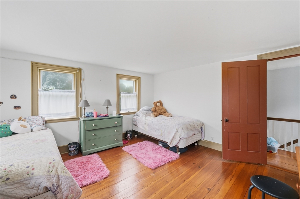 21 Rocky Hill Road Andover, MA 01810 - Photo 14 of 35 a bedroom with a bed and wooden floor