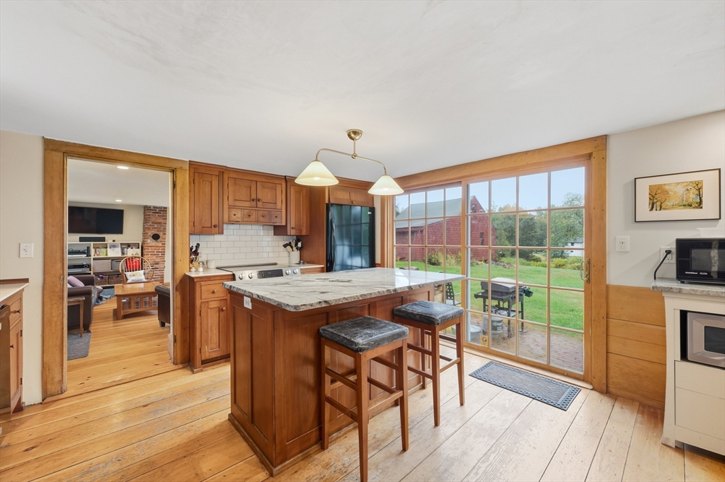 21 Rocky Hill Road Andover, MA 01810 - Photo 7 of 35 a kitchen with stainless steel appliances granite countertop a stove and a view of living room