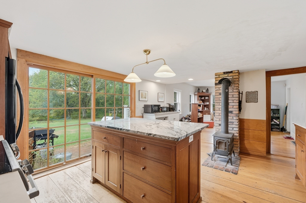 21 Rocky Hill Road Andover, MA 01810 - Photo 8 of 35 a kitchen with a stove a refrigerator and wooden floor