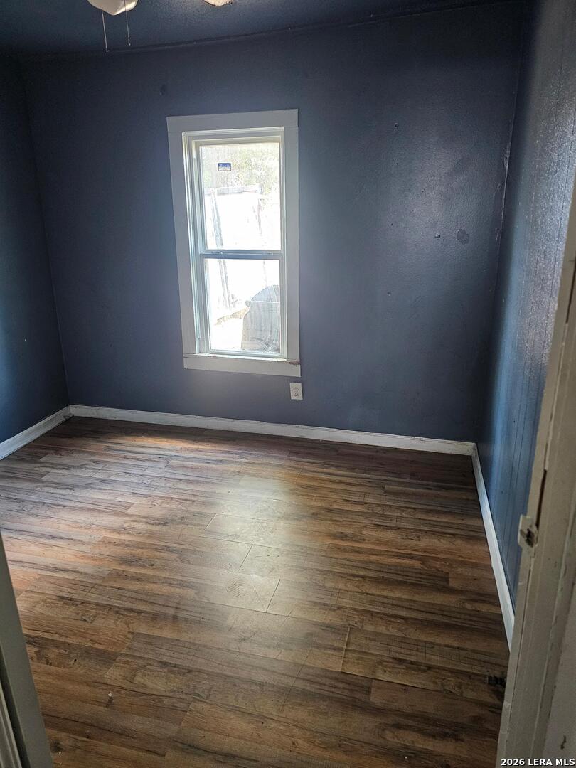 701 Roosevelt Street Longview, TX 75601 - Photo 6 of 8 a view of an empty room with wooden floor and a window