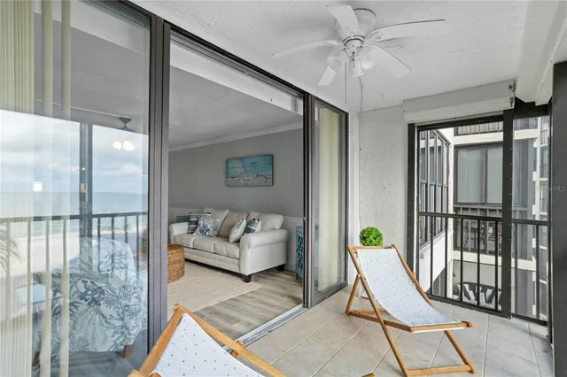 a view of a dining room with furniture a chandelier and wooden floor