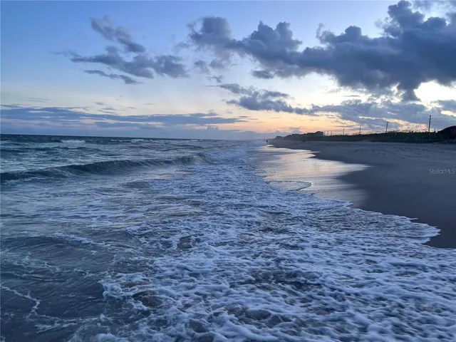 a swimming pool with outdoor seating and barbeque oven