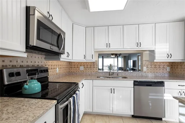 a kitchen with stainless steel appliances granite countertop a sink and cabinets