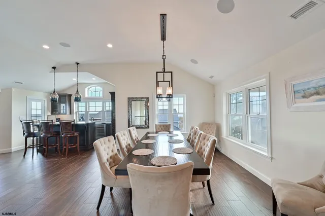 a kitchen with stainless steel appliances white cabinets and wooden floors