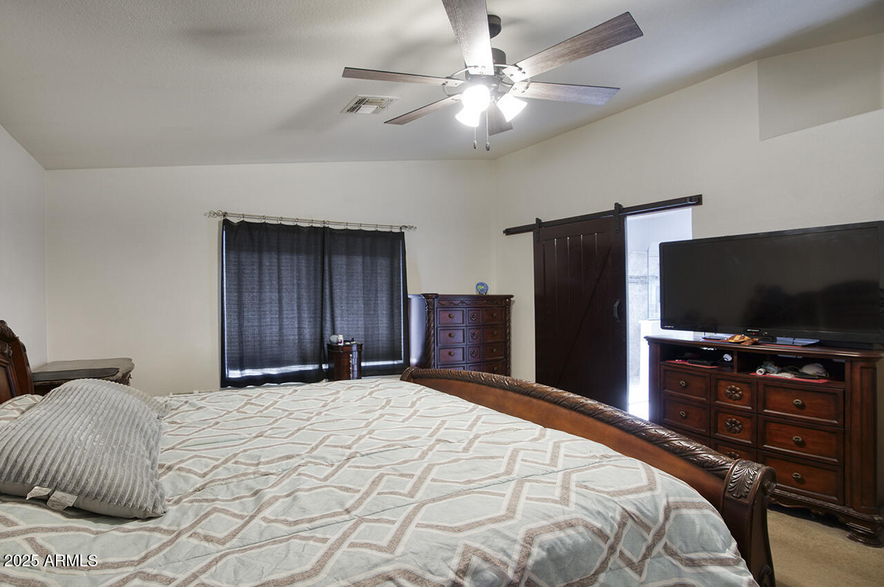 12677 North 77th Drive Peoria, AZ 85381 - Photo 15 of 25 a bedroom with a bed and a flat screen tv